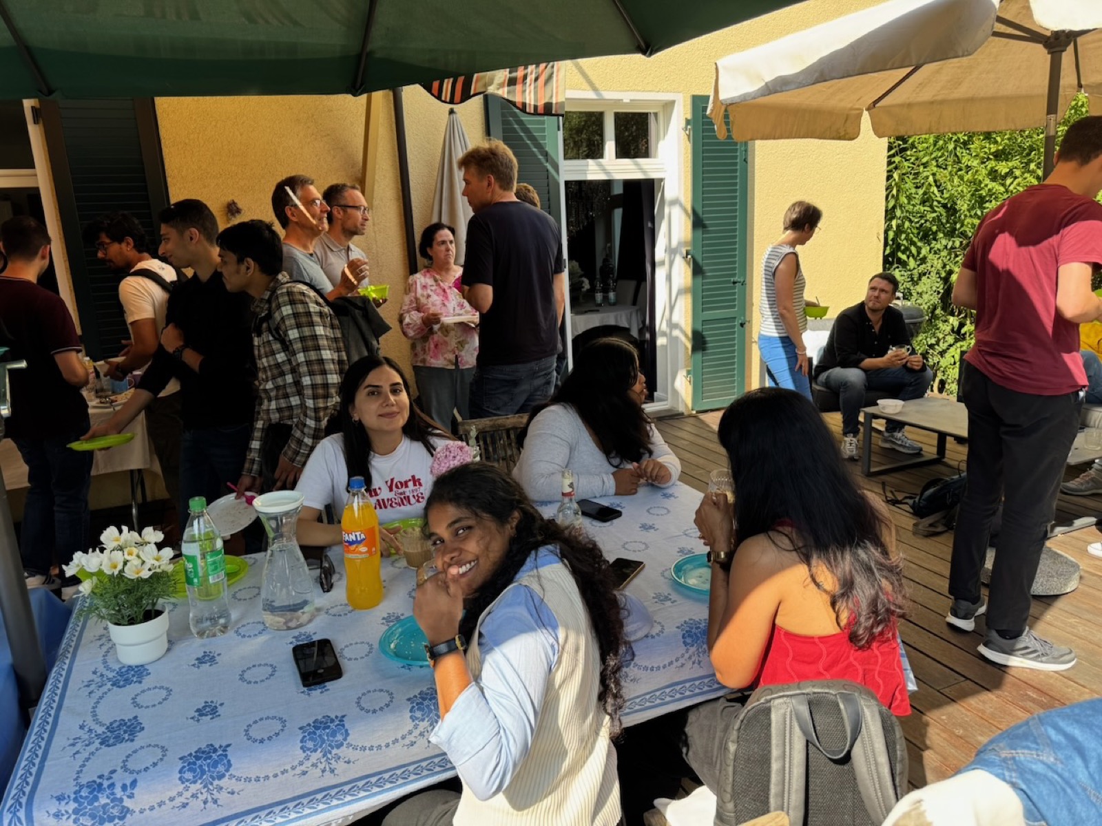 International master's students talking at the garden party